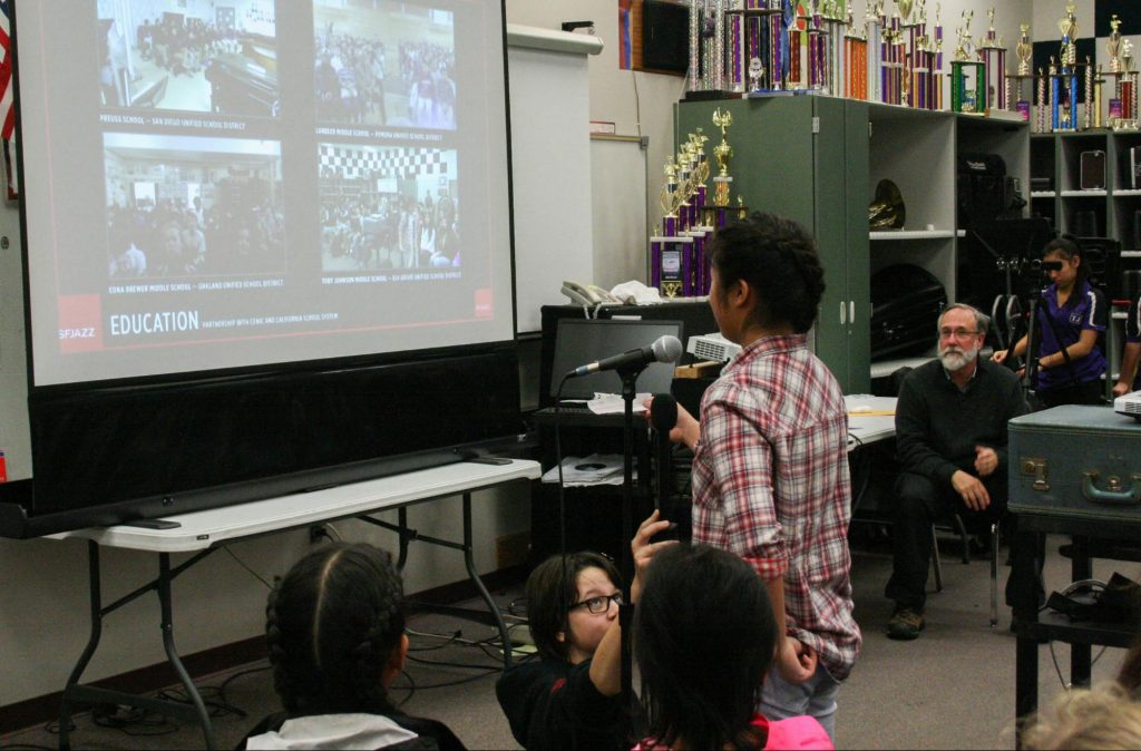 TJMS Jazz Band member Caylie steps up to microphone for Q&A with SF Jazz.